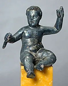 Silver statuette of a seated boy