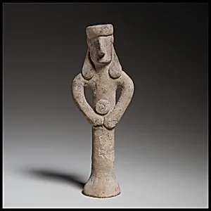 Standing figure holding a tambourine(?)
