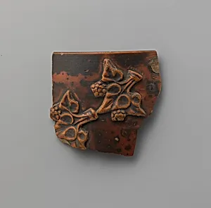 Terracotta applique fragment of ivy leaves and berries