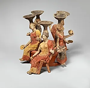 Terracotta group of women seated around a well head