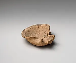 Terracotta saucer-shaped oil lamp