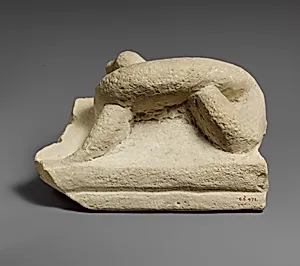 Two fragments of a limestone sarcophagus lid with snakes