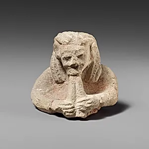 Upper part of a limestone male aulos player