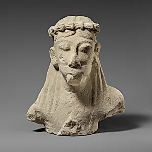 Upper part of a limestone statuette of a male aulos player