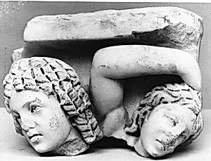 Upper right corner of a marble sarcophagus: head of a Black African and a maenad
