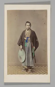 [Japanese Naval Officer][Studio Portrait: Japanese Man (Tateise Onogero) Standing Holding Hat and Sword]