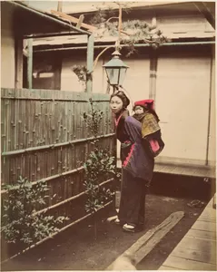 [Japanese Woman in Traditional Dress Posing with a Child on her Back]