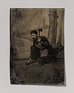 [Kneeling Carpenter Holding a Nail and Raised Hammer] by Unknown