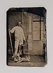 [Painter, Standing in Front of a Painted Window Backdrop, with Brushes, Bucket, and Paint Cans] by Unknown