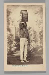 [Studio Portrait: Male Street Vendor with Barrel on Head, Brazil]
