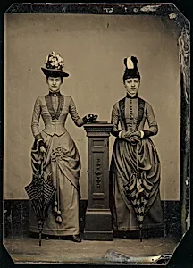 [Studio Portrait of Two Women Holding Folded Parasols] by Unknown