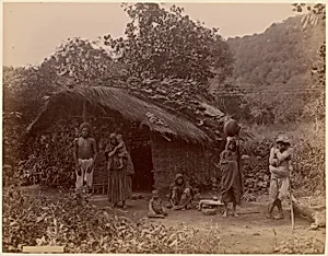 [Thatched House, People in Foreground, Telegraph Lines in Background] by Unknown