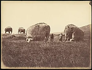 [Two Men by Monumental Elephant Statues, China] by Unknown