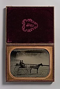 [Two Men Seated in a Horse-Drawn Carriage in Front of Niagara Falls] by Unknown