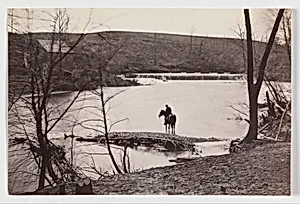 [View of Mounted Soldier? Watering his Horse in Bull Run, Blackburn's Ford, Virginia] by Andrew Joseph Russell|Timothy H. O'Sullivan|George N. Barnard|Mathew B. Brady