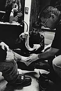 Boston (At the Boston Night Center, Toni Abraham, a nurse practitioner from the Boston Health Care for the Homeless program, supervises while nurse Jack Castro and Mark Lepore, a student from Boston University Medical School, bandage the badly infected foot of a homeless man. Often, homeless people will first present themselves to health personnel when they have serious problems with their feet. Swelling of the feet and legs, cellulitis, and skin ulcerations are common among people living on the street. Inadequate opportunities to bathe, ill-fitting and wet shoes, and exposure to the elements all contribute to medical problems. "When your feet don't work, you can’t do the things that you need to do," says one.)