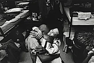 Boys in the shelter hug Pierre Garrett after a tearful confrontation with his mother. Olive Branch Mission, Chicago.
