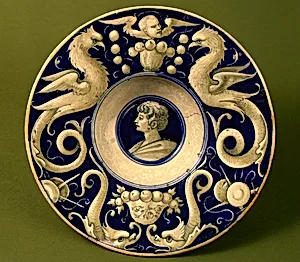 Broad-rimmed bowl with border of dolphins and "delphigriffs"; in the center, head of a young man by Probably Urbino district 16th Century