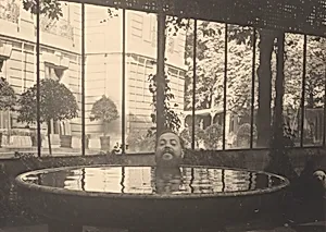 Christian Bérard's Head Posed at Edge of Basin of Water, Appearing to Float in the Water at the House of La Vicomtesse de Noailles