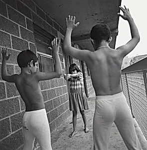 Hector, Jessica, and Pablo Sanchez playing cops and robbers at a HELP USA site, Bronx, New York