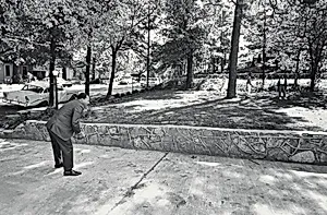 In the front yard of his Atlanta home, Dr. King takes time out for a game of catch with his sons