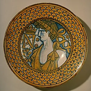 Large dish with scale border; in the center, an imperial Roman figure and the letter N crowned