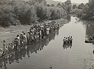 Members of the Primitive Baptist Church in Moorehead, Kentucky, attending a creek baptizing by submersion