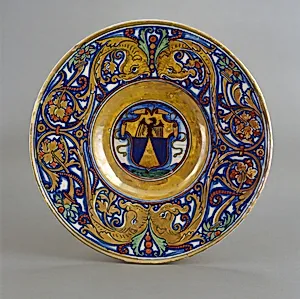 Plate with border of foliate scrollwork with dolphin heads and cornucopias; in the center, shield of arms of Vigerio of Savona