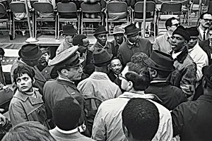 Surrounded by supporters, advisors, and security personnel, Dr. King, Jr. prepares for his speech at the United Nations