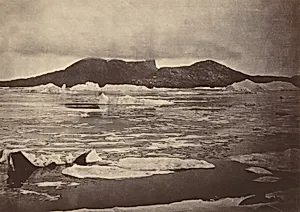 The Arctic Regions: No. 92.* The Devil's Thumb partially enveloped in a fog, with the first of the drift Ice from the pack, which was being forced towards the land, from which we escaped through a narrow lead; had we been hemmed in, we should have had to winter there