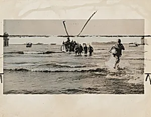 Title from caption on object: “Racing Off a Landing Boat...”