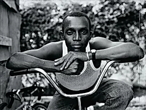 Young Man Resting His Arms on Bicycle, Amityville, New York