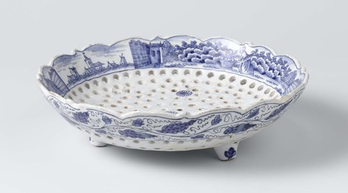 Natfruitschaal van blauw beschilderde faience, met gaatjes in een bloemvorm