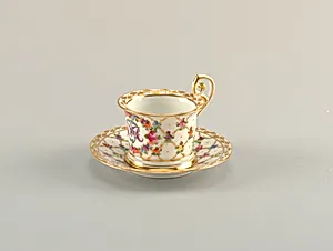 Cup and Saucer with Monogram and Diamond Lattice Pattern