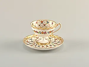 Footed Cup and Saucer with Diamond Lattice Pattern