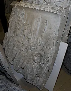Kejser Marcus Aurelius står på en tribune mellem to mænd og taler til tropperne by Ubekendt