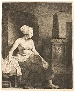 Kvindelig model, halvt påklædt, siddende ved en ovn by Rembrandt van Rijn