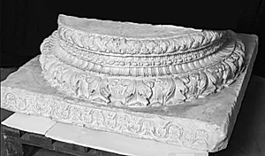 Plinth med ornament på ene side, herover cavetto mellem vulster, ornamenteret by Ubekendt