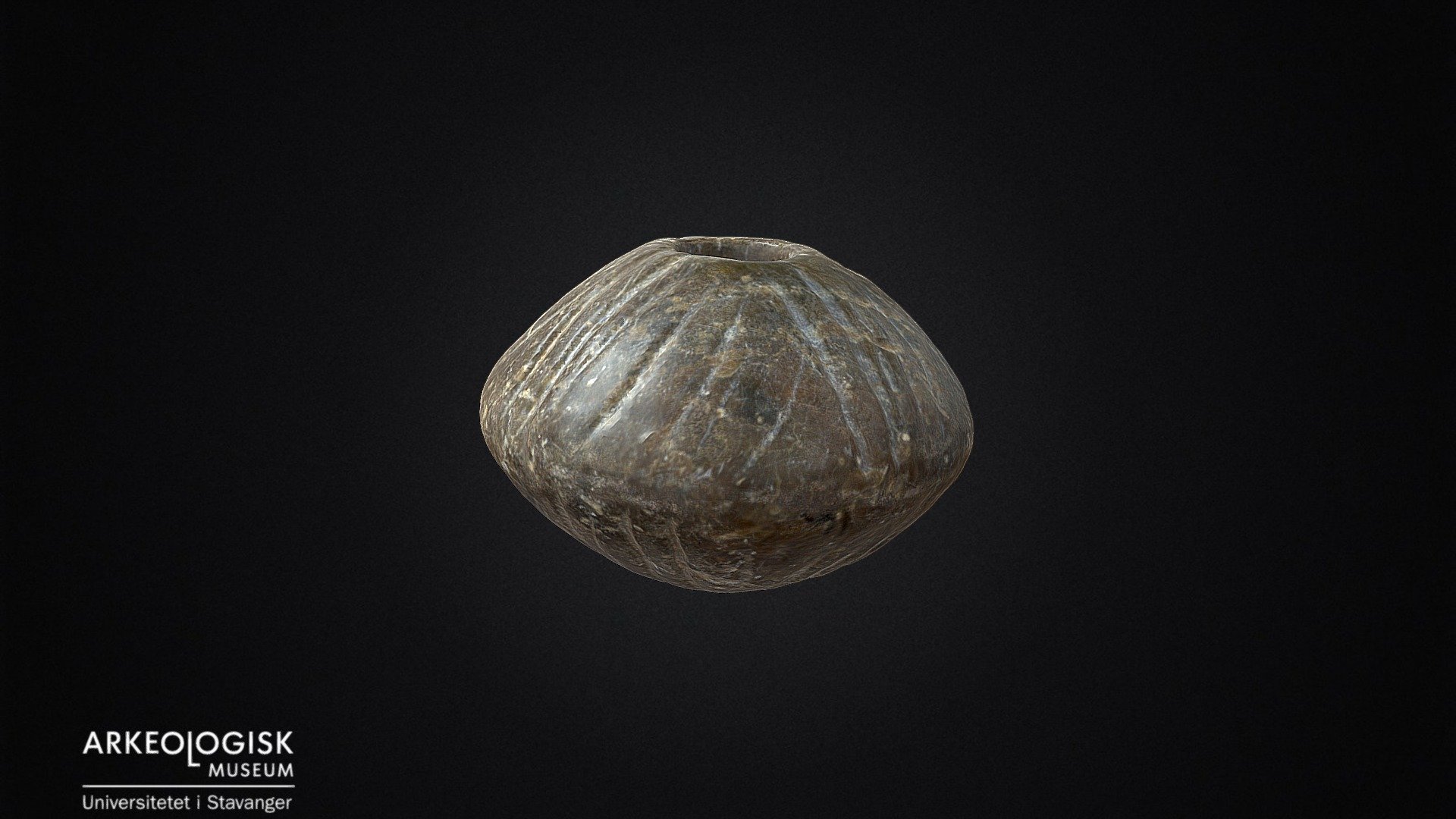 Ornamented spinning wheel of soap stone.