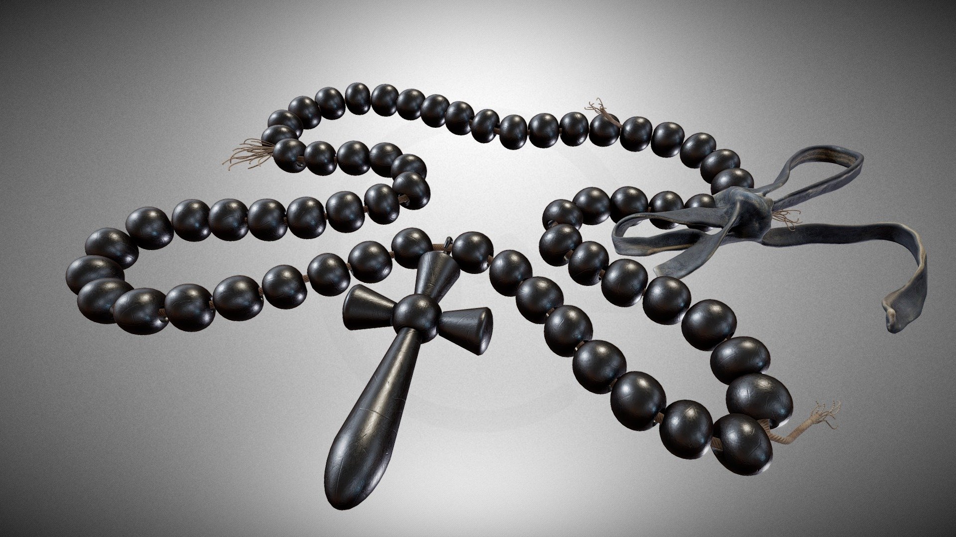 A black pendant with a cross – a prop